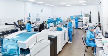 A researcher looking through a microscope in a laboratory