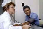 nurse checking a patient's blood pressure