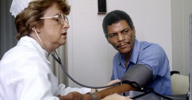 nurse checking a patient's blood pressure