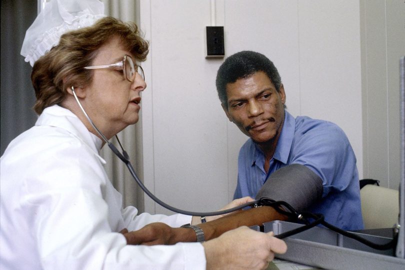 nurse checking a patient's blood pressure