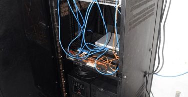 blue network cables organised in a server room