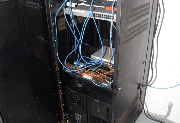 blue network cables organised in a server room