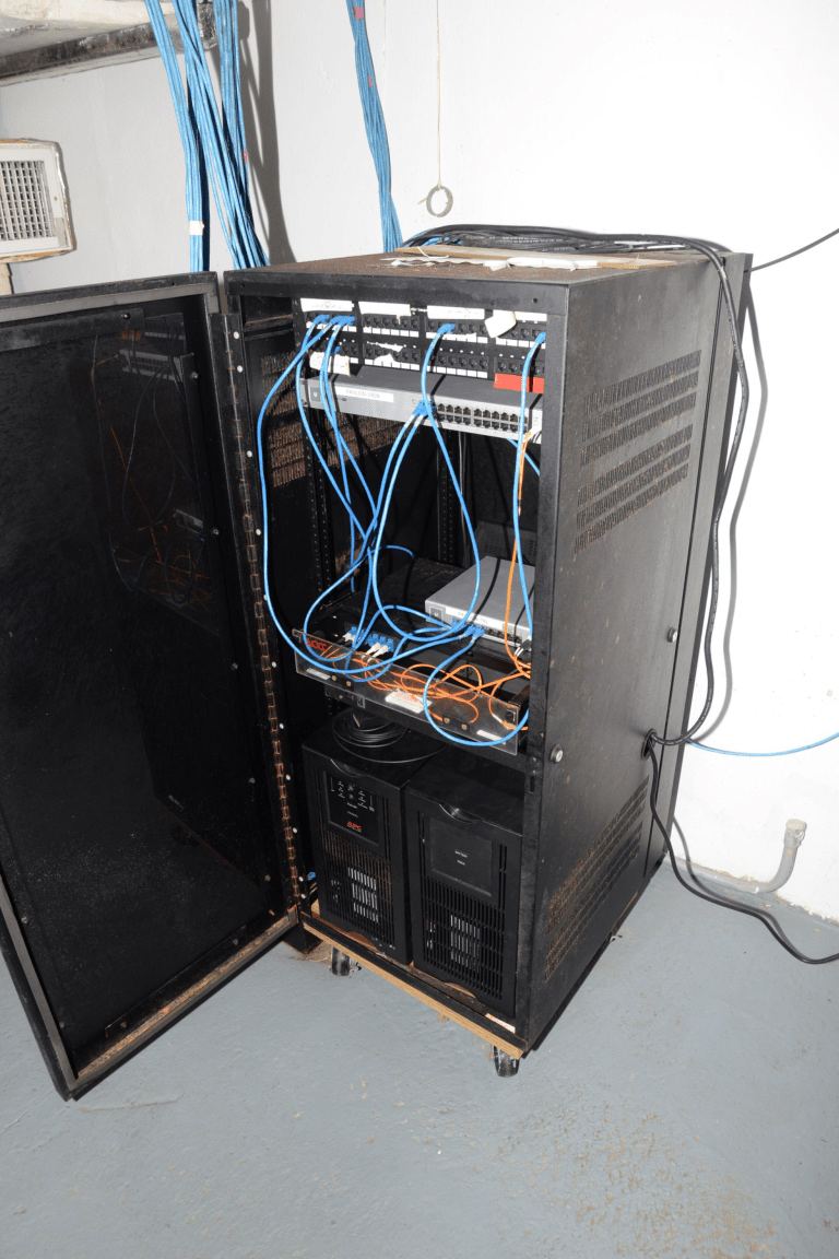 blue network cables organised in a server room