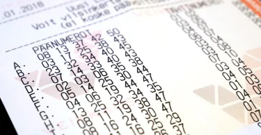 A European lottery ticket held beside its printed entry form