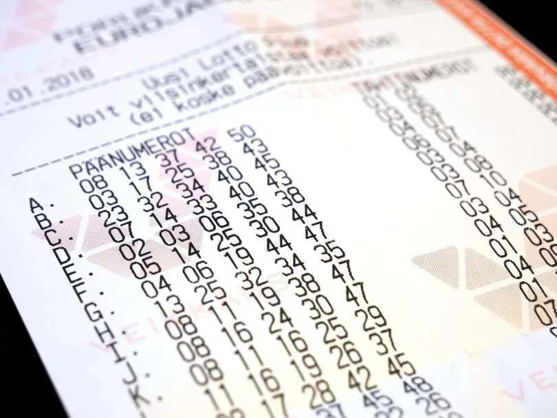 A European lottery ticket held beside its printed entry form
