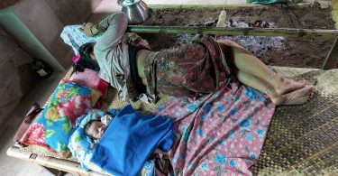 A person sleeping peacefully in a dark bedroom