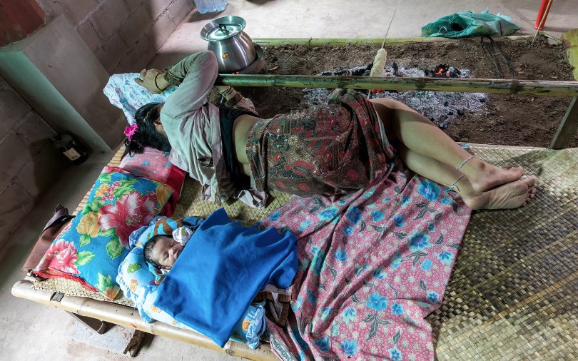 A person sleeping peacefully in a dark bedroom