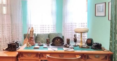 A writing desk lit by a lamp late at night