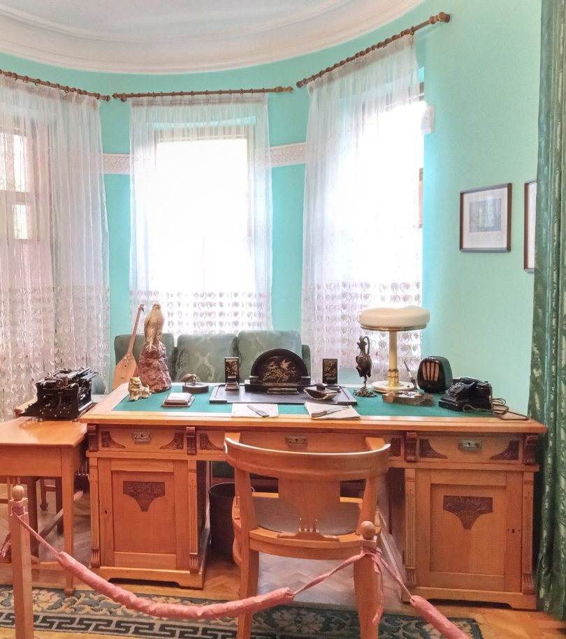 A writing desk lit by a lamp late at night