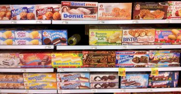 Assorted groceries and packaged foods on a supermarket shelf